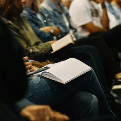 Person with an open bible in church.